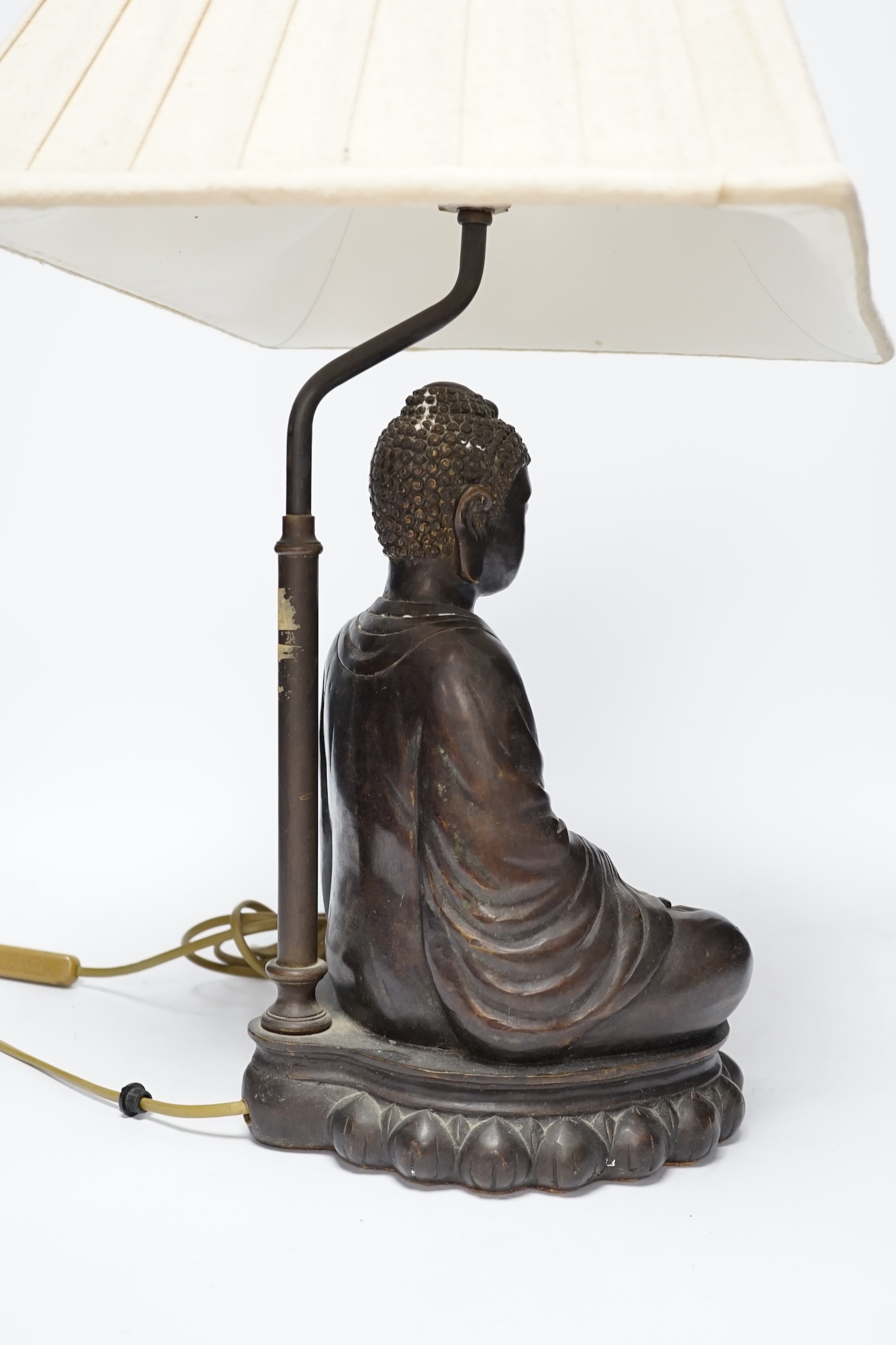 A bronzed Buddha table lamp, 57cm high including shade